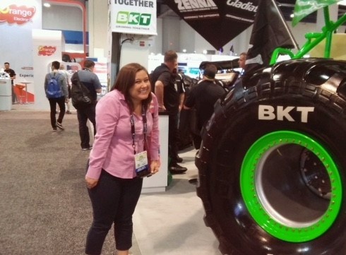 Sarah next to a vehicle at SEMA