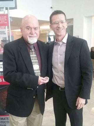 Bill DeTellis reciving challenge coin from David Stringer