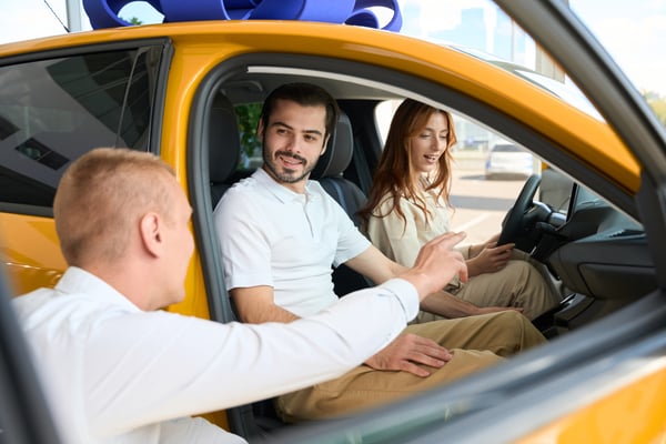 car-salesman-demonstrating-dashboard-to-potential-2022-11-15-11-19-27-utc