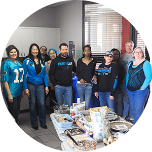 Employees posing at tailgate party
