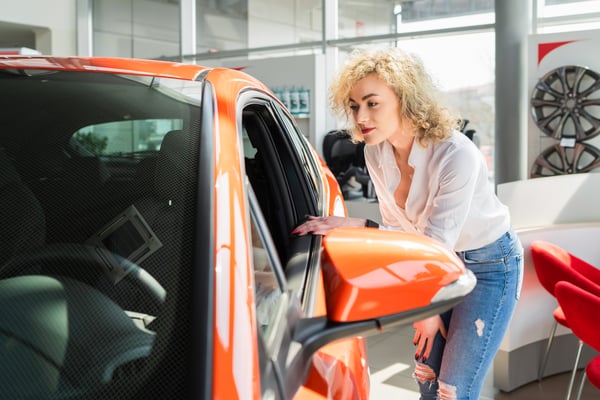 curly-woman-looks-car-at-the-dealership-2022-02-02-22-06-44-utc