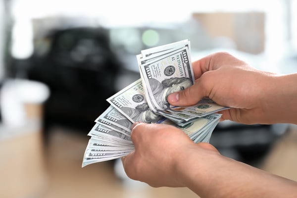 man-with-money-in-automotive-shop-closeup-buying-2026-03-26-23-48-23-utc