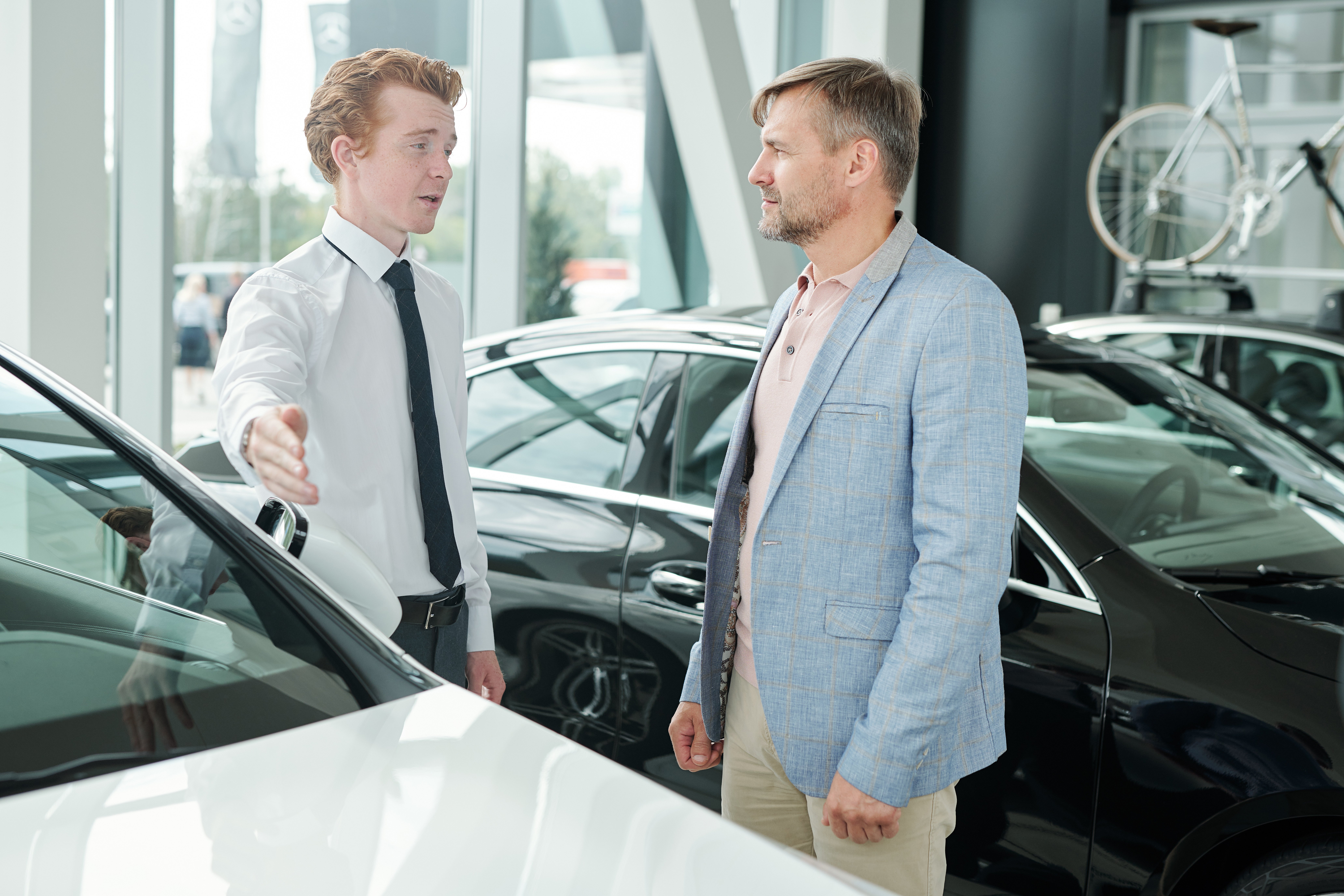 mature-man-looking-at-young-sales-manager-pointing-2021-09-24-03-21-24-utc
