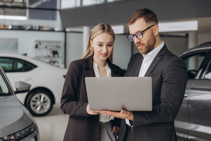 portrait-of-two-workers-with-laptop-inside-car-sho-2025-02-25-21-46-34-utc