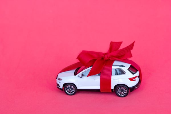 toy-new-car-gift-with-red-bow-on-red-background-2023-11-27-05-21-40-utc