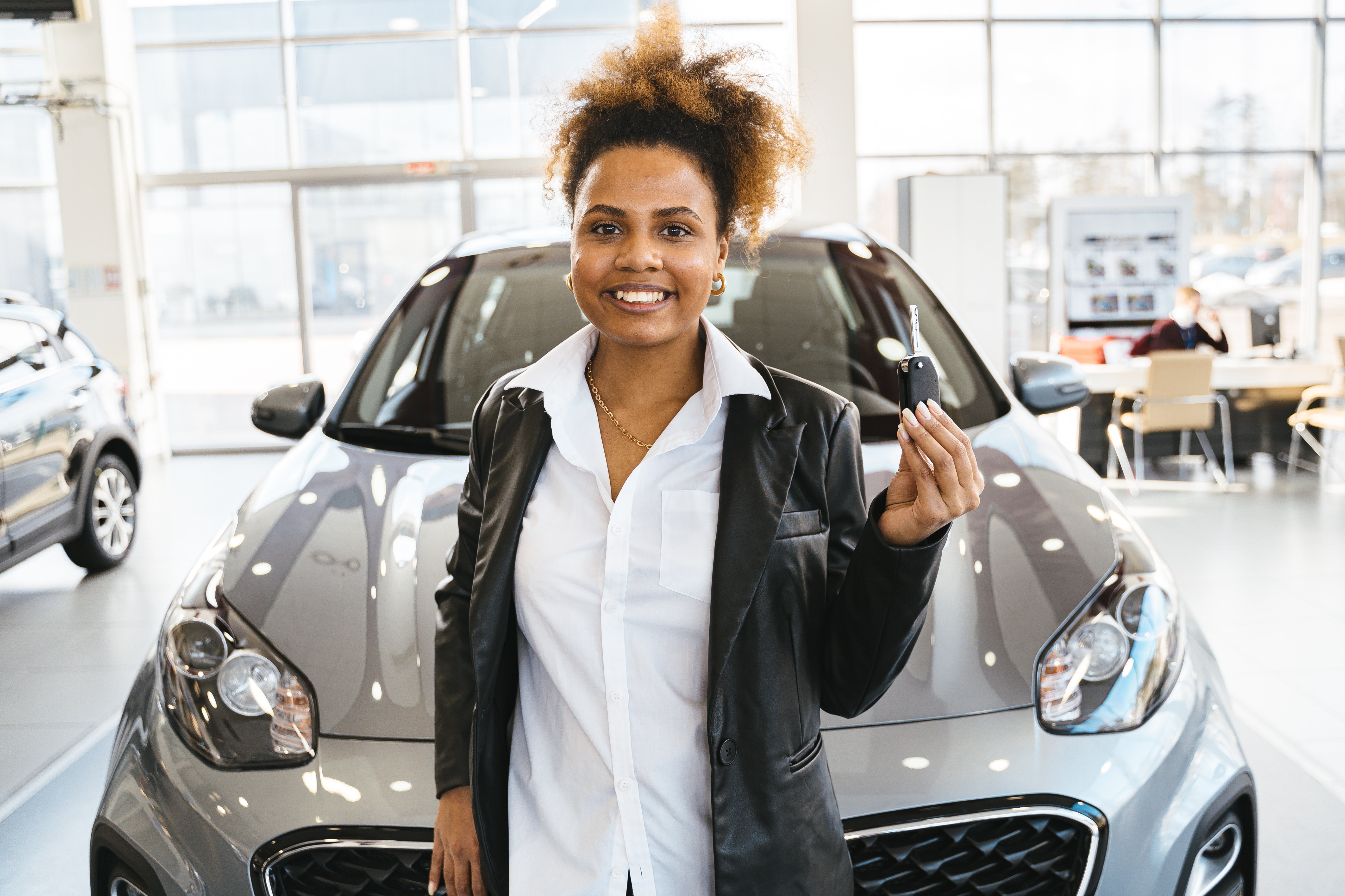 woman in dealership with car fob