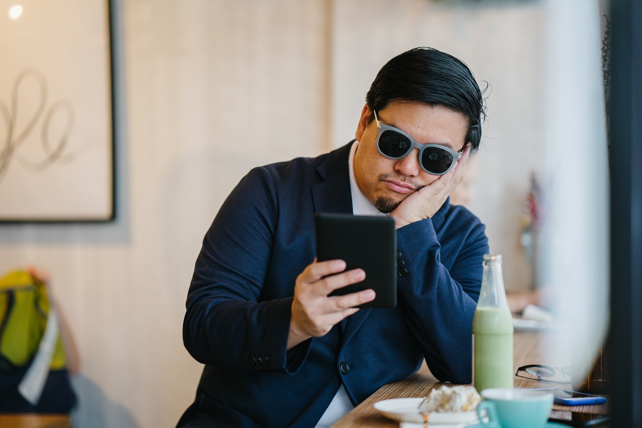 bored man looking at phone